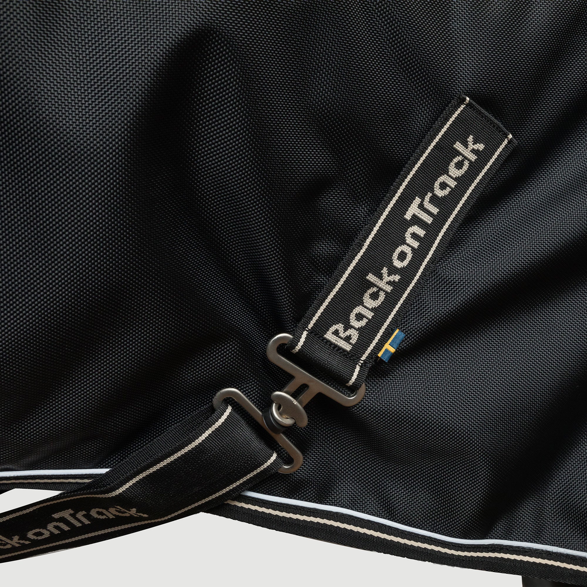 Back on Track Obsidian Turnout Blanket with Neck Cover for horses, offering weather protection and therapeutic support